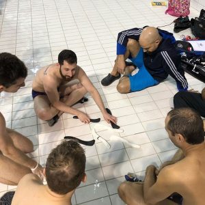 Underwater hockey strategy discussed on the pool deck